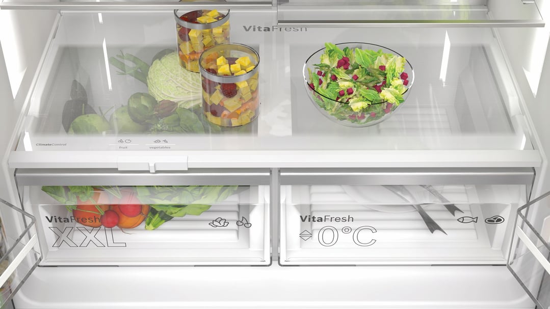 Inside view of a Bosch fridge freezer with fresh fruit and vegetables
