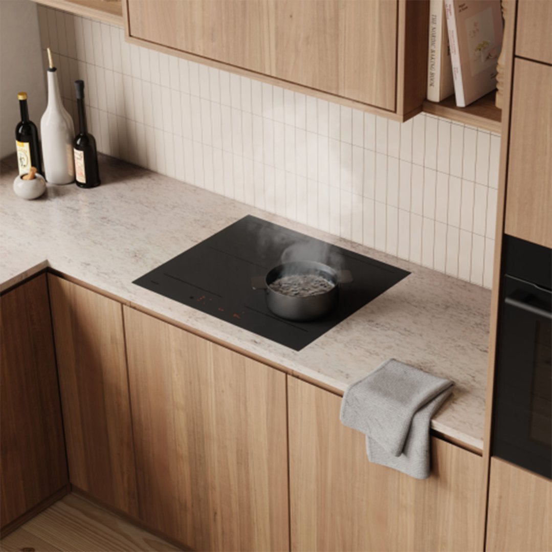 Black induction cooktop with a boiling pot in a modern kitchen setting