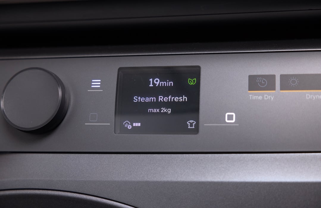 Close up of a dryer's control panel displaying "Steam Refresh" cycle
