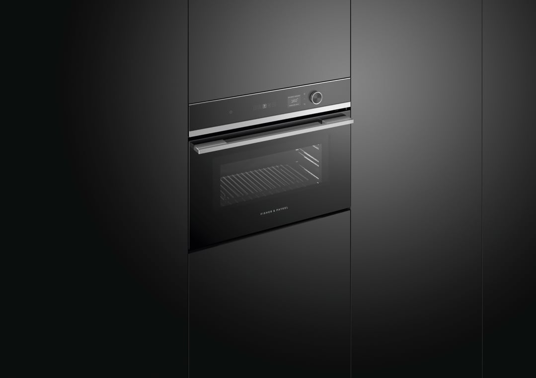 Built-in compact combi-microwave oven with a black finish in a dark kitchen setting