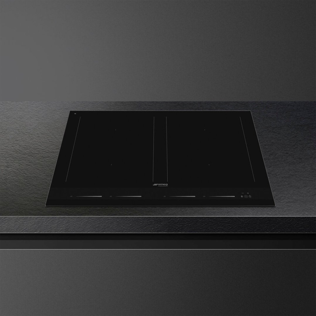 Black induction cooktop with controls on a dark countertop