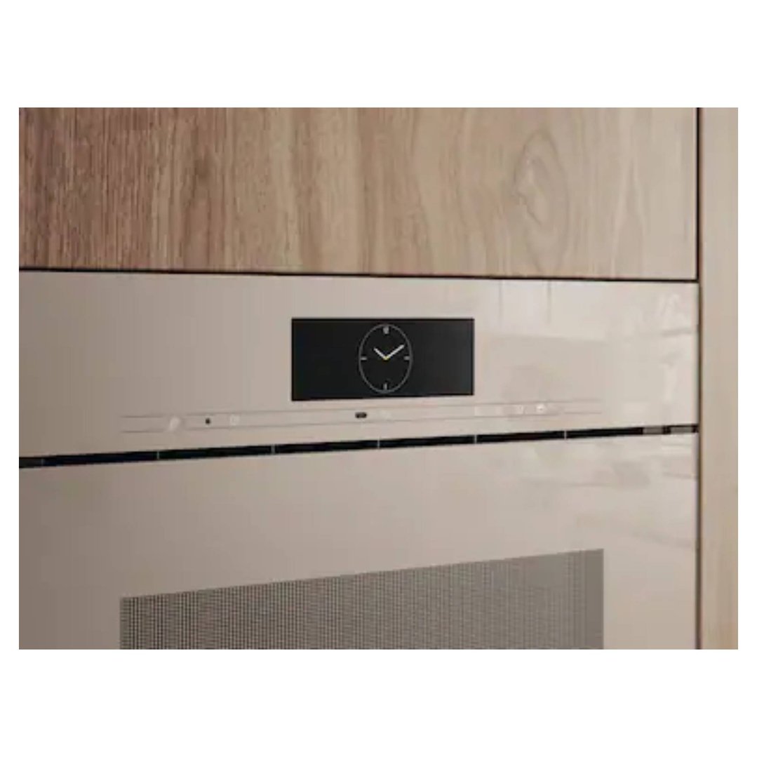 Combination steam oven with a clock display built into a wooden kitchen cabinet