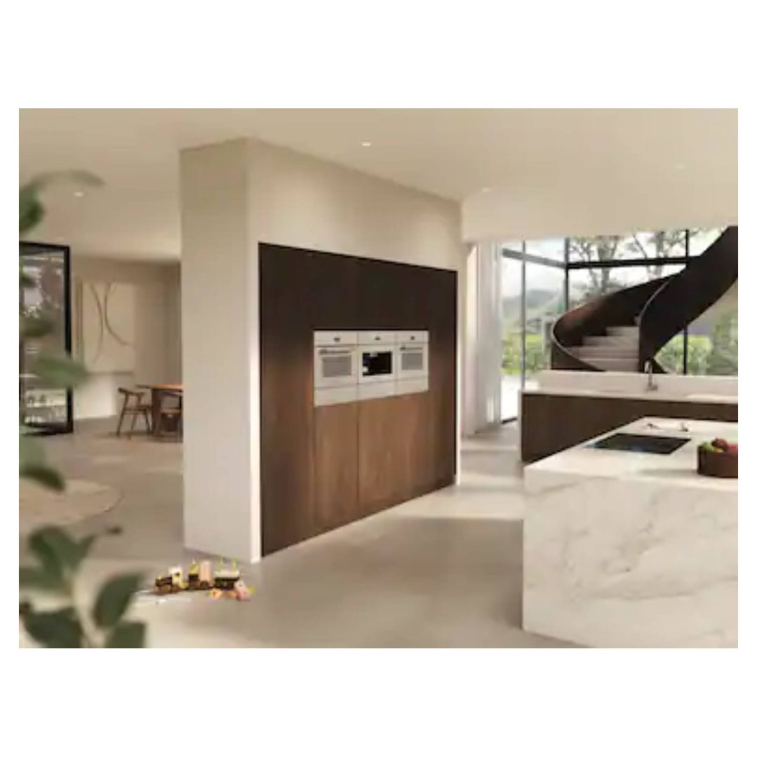 Combination steam oven built into a dark wood wall in a modern kitchen