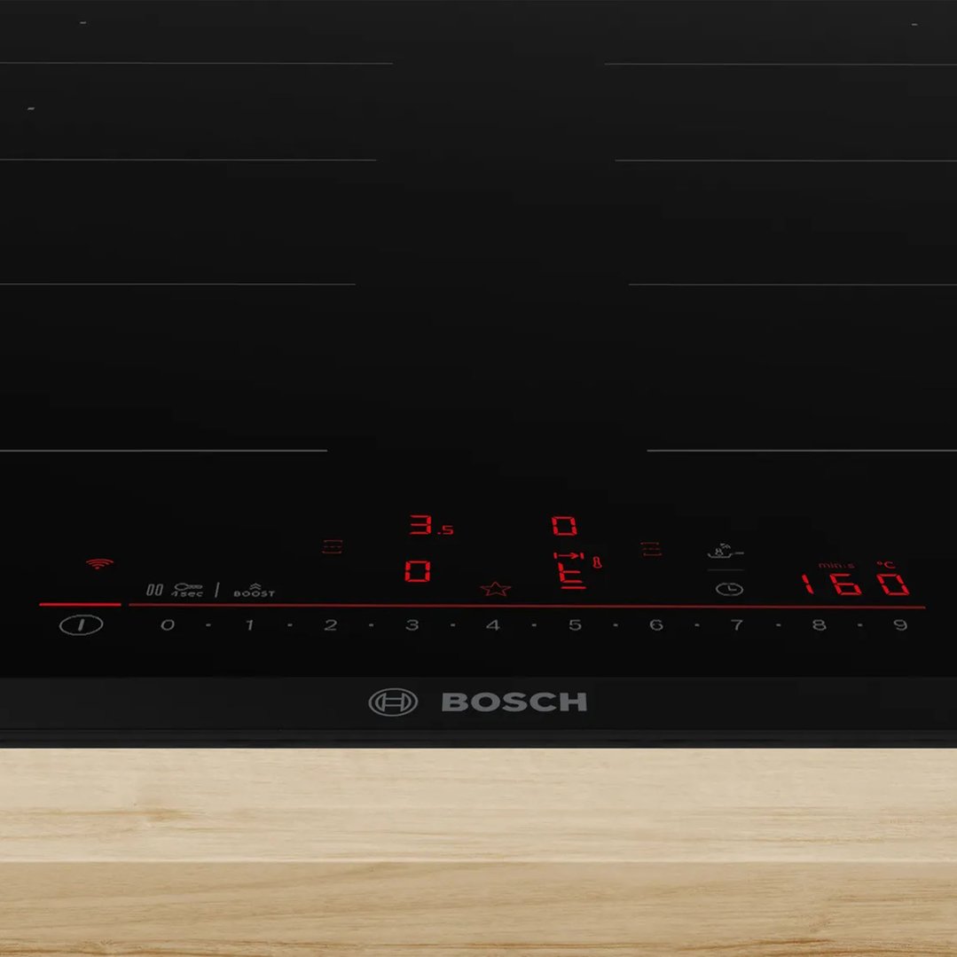 Bosch Series 6 Flex Induction Cooktop with illuminated controls on a wooden surface