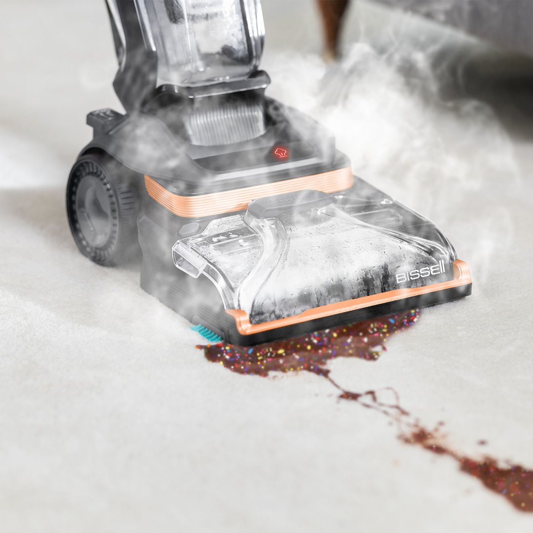 BISSELL Revolution HydroSteam vacuum cleaner cleaning a chocolate spill on a carpet