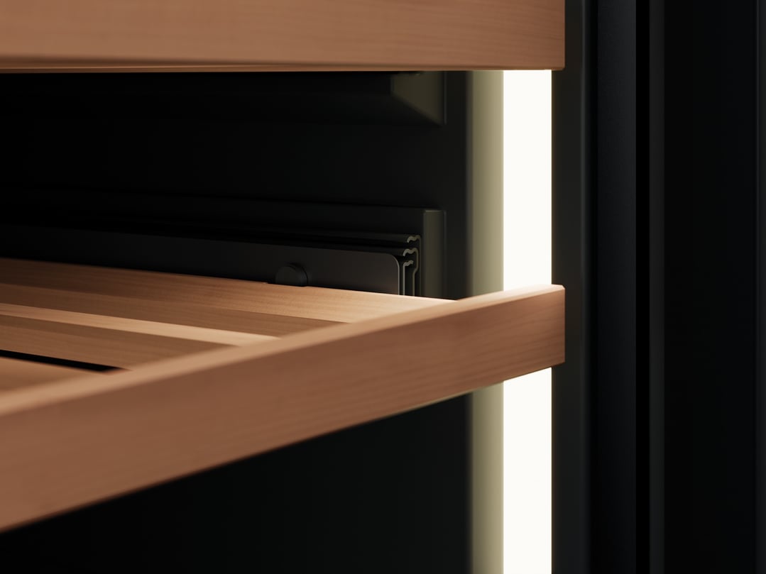 Close-up of a wine cabinet interior with wooden shelves and internal lighting