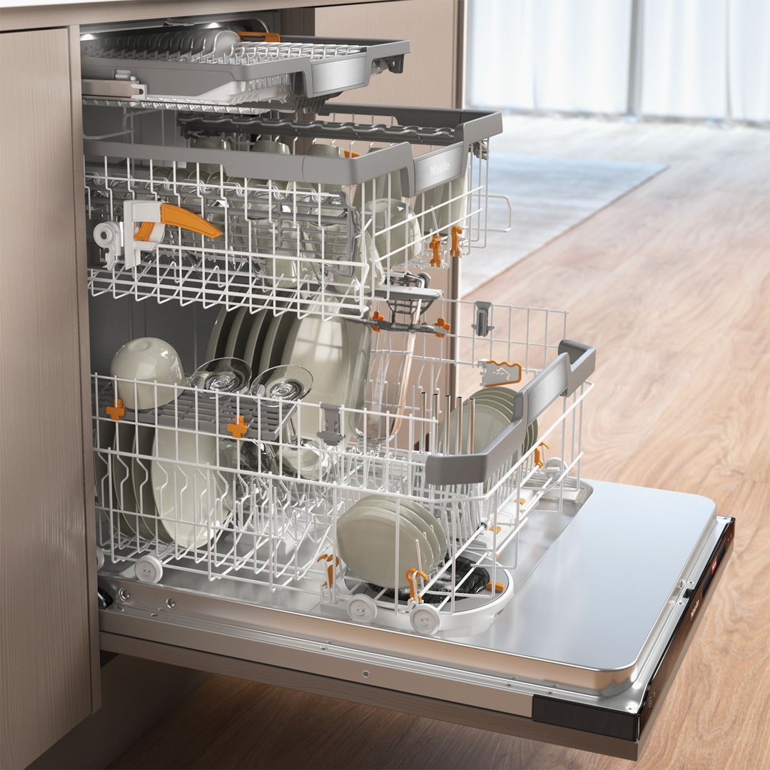 Open integrated dishwasher with racks full of dishes in a kitchen setting