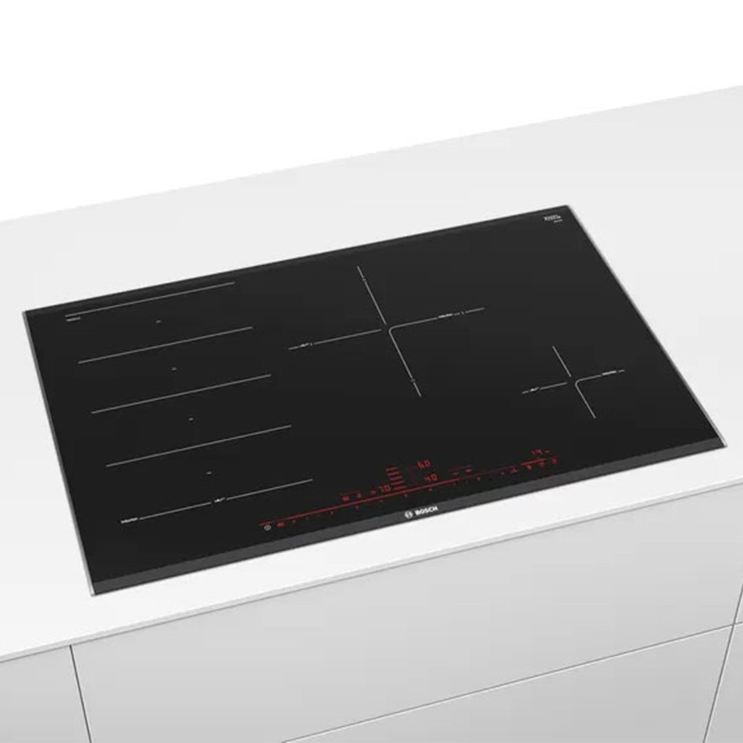 Black Bosch induction cooktop with red controls built into a white countertop