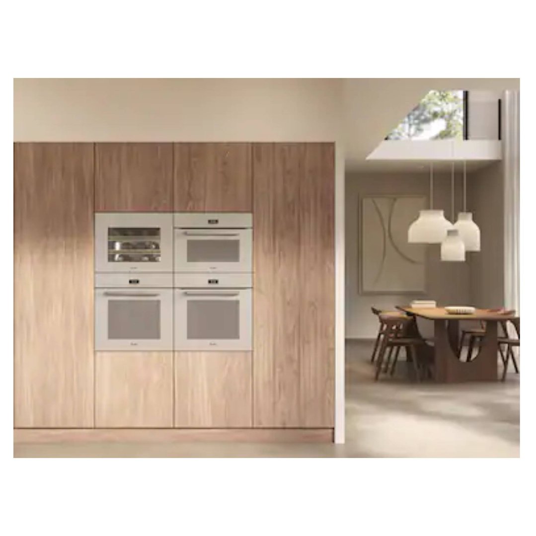 Four built-in ovens in a wooden cabinet in a modern kitchen setting