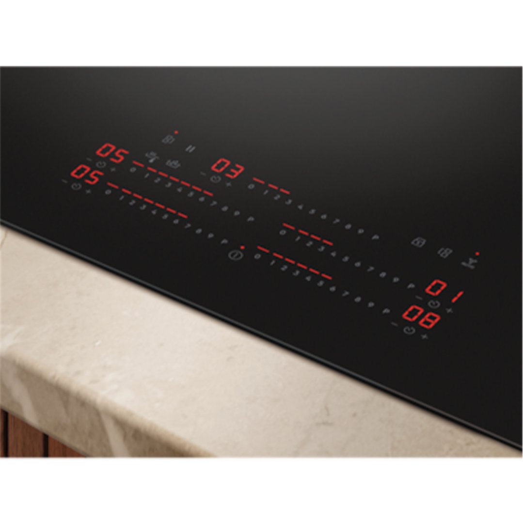 Close up of a black induction cooktop with red digital controls