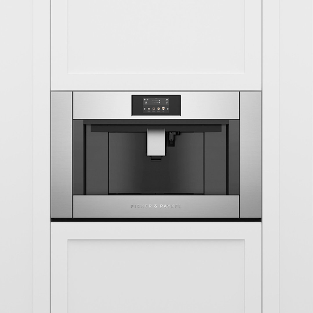 Built-in coffee maker with a digital display installed in white kitchen cabinetry
