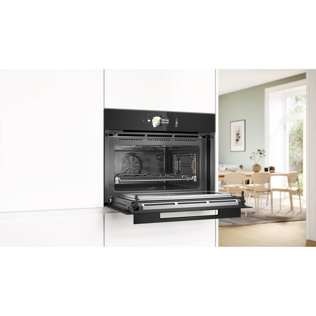 Built-in microwave oven with door open in a modern kitchen setting
