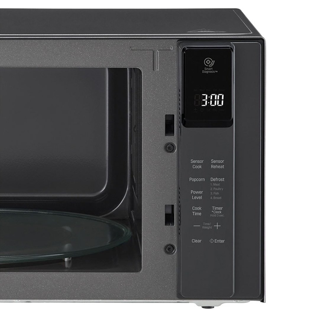 Close-up of a dark grey microwave oven with its door slightly ajar