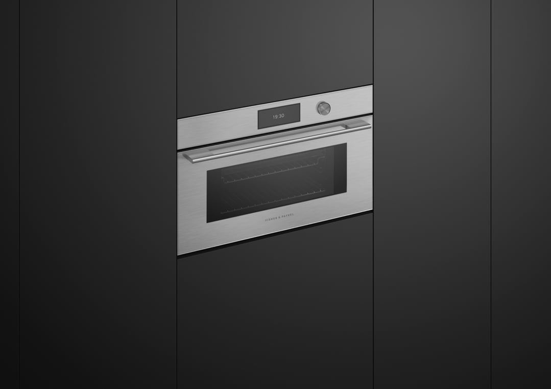 Built-in microwave oven with digital display in a dark kitchen cabinet