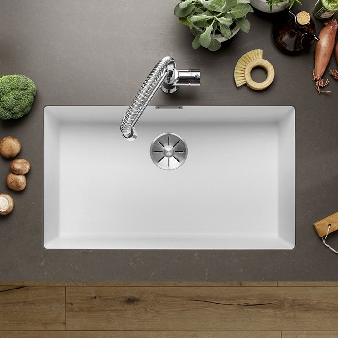 White BLANCO sink with a chrome faucet in a kitchen setting