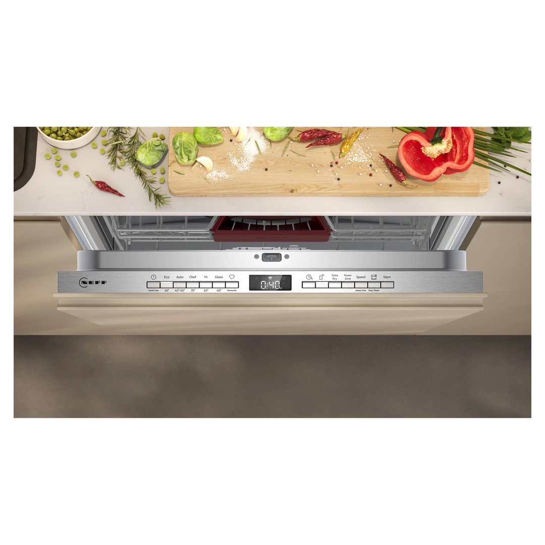 Fully-integrated dishwasher with control panel visible, surrounded by kitchen counter and ingredients