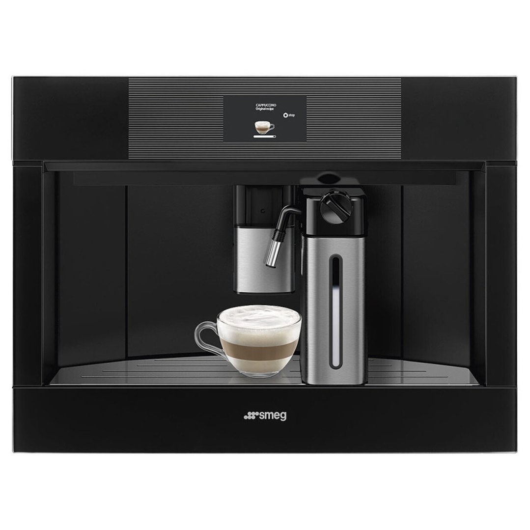 A built-in coffee machine with a glass cup of cappuccino on the drip tray