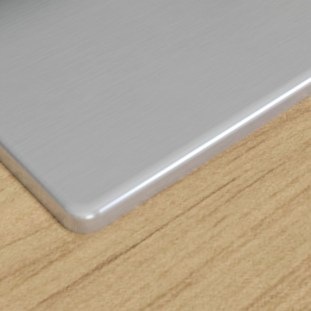 Close-up of the stainless steel cooktop edge on a wooden countertop