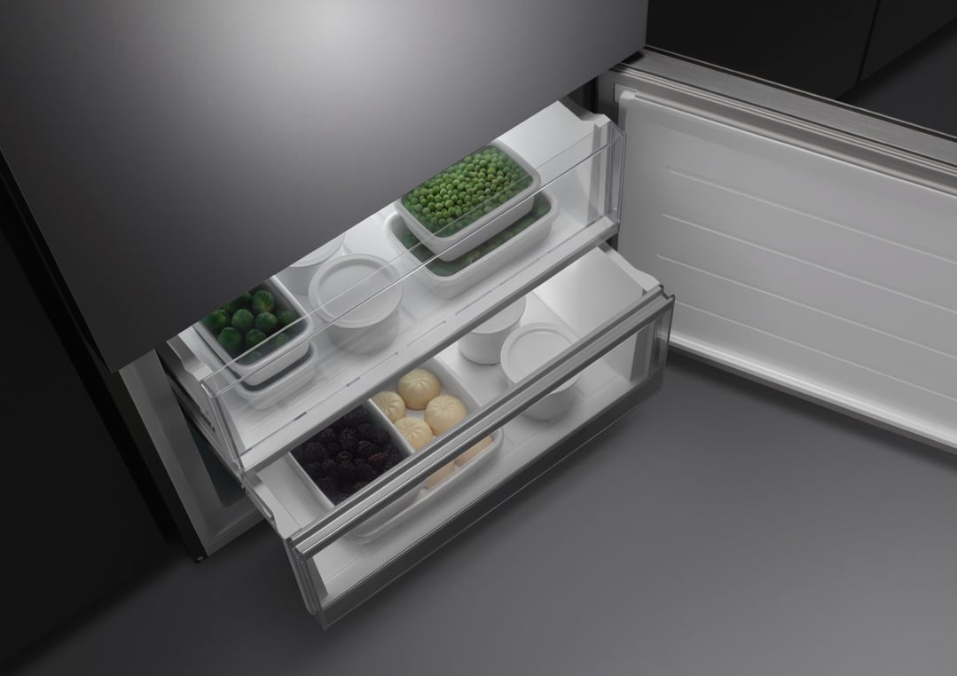 Open bottom freezer drawer of a fridge with food containers inside