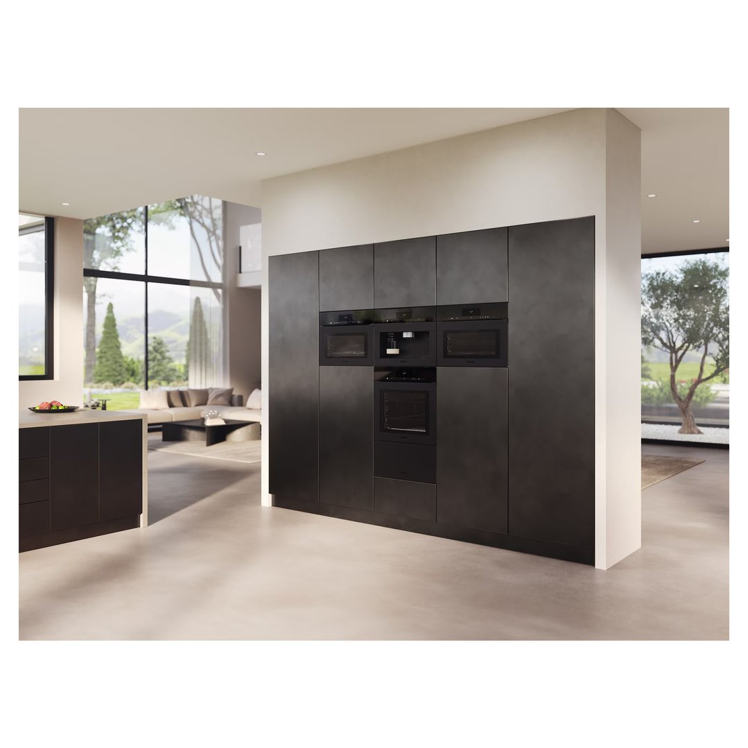 Built-in microwave and other appliances in a modern kitchen with living area
