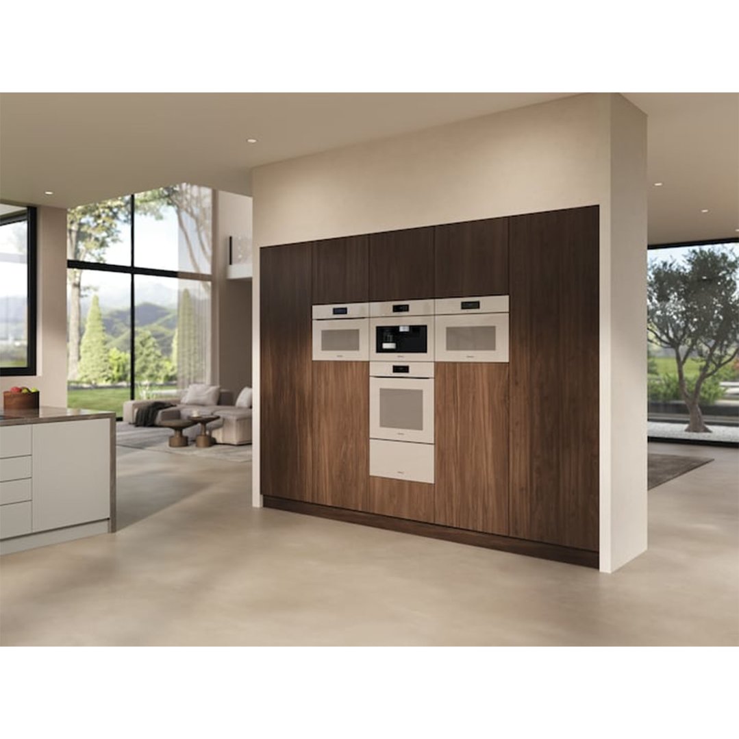 Pearl beige oven and other appliances built into a dark wood wall in a modern kitchen