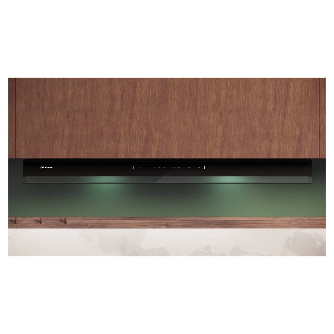 Black integrated rangehood with illuminated controls under wooden cabinets
