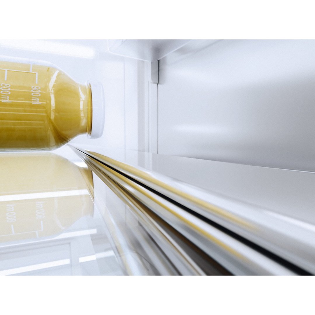 Close up of a bottle of juice inside a fridge