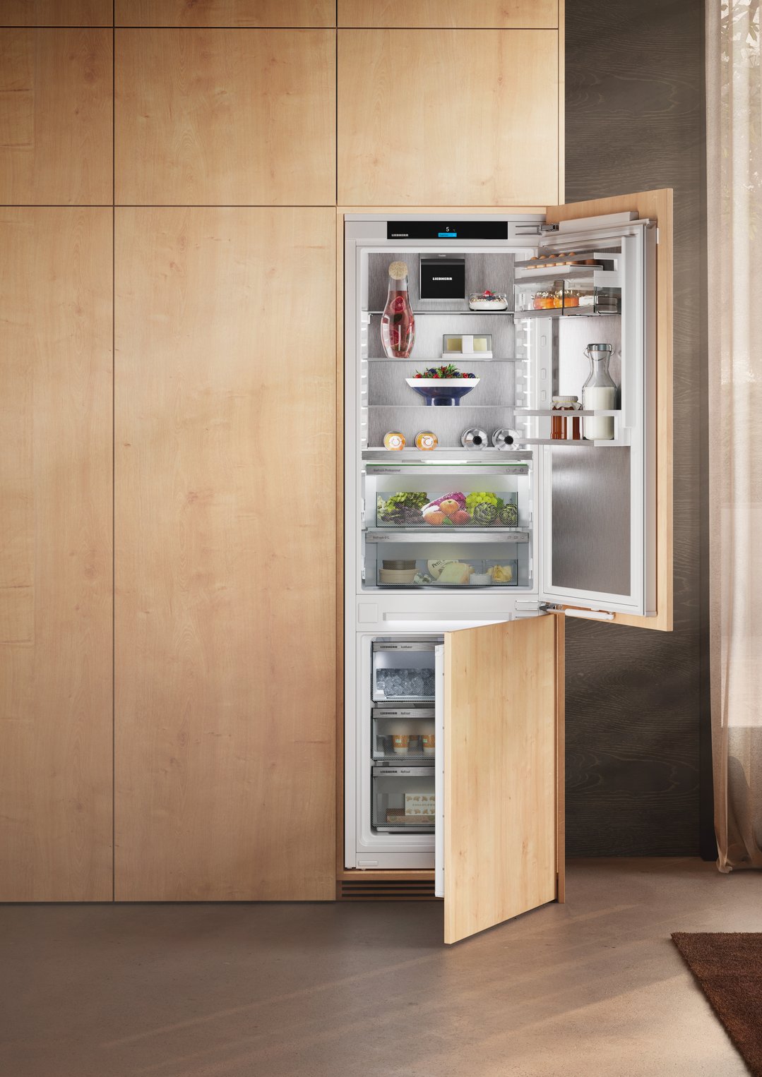 Integrated Liebherr fridge freezer with open doors in a modern kitchen setting