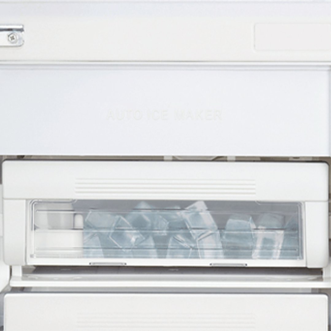 Close up of the automatic ice maker in a white fridge, full of ice cubes