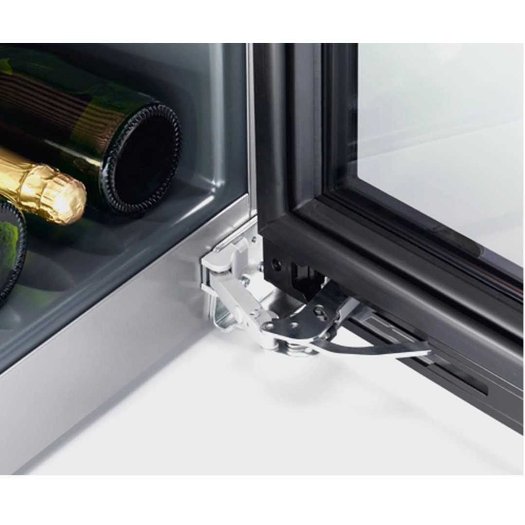 Close-up of the open door hinge of a wine conditioning unit with bottles inside