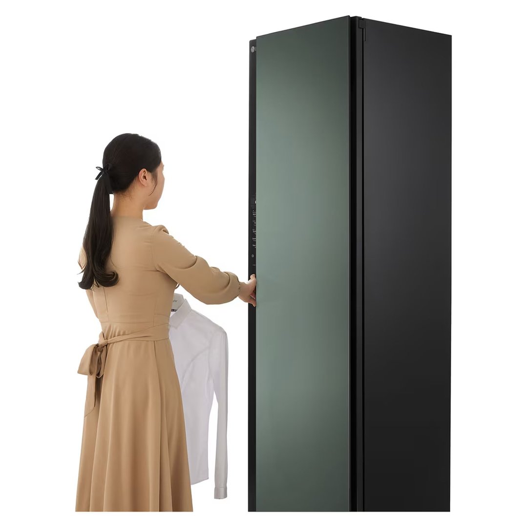 Woman loading a white shirt into a black LG Styler dryer