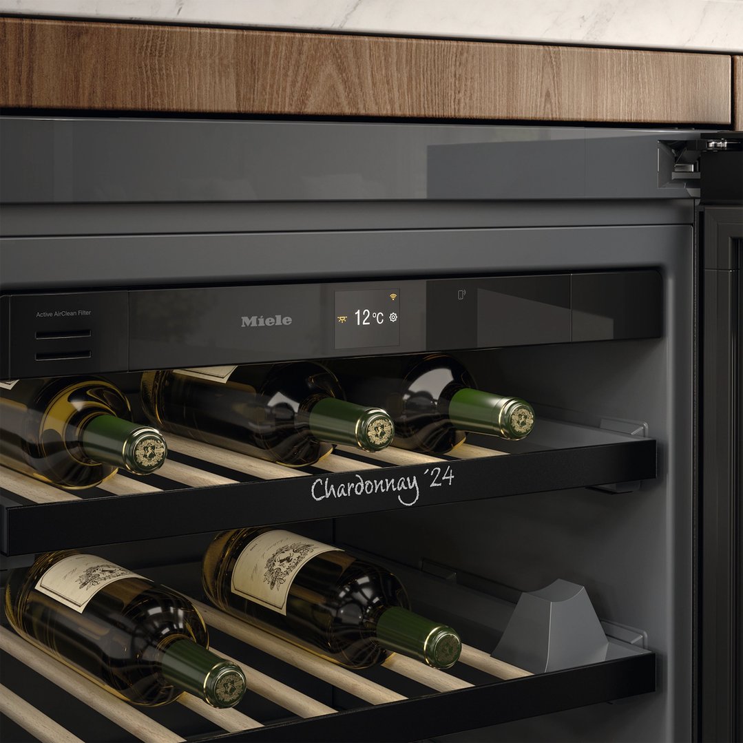 Close up of a Miele wine conditioning unit with bottles on shelves
