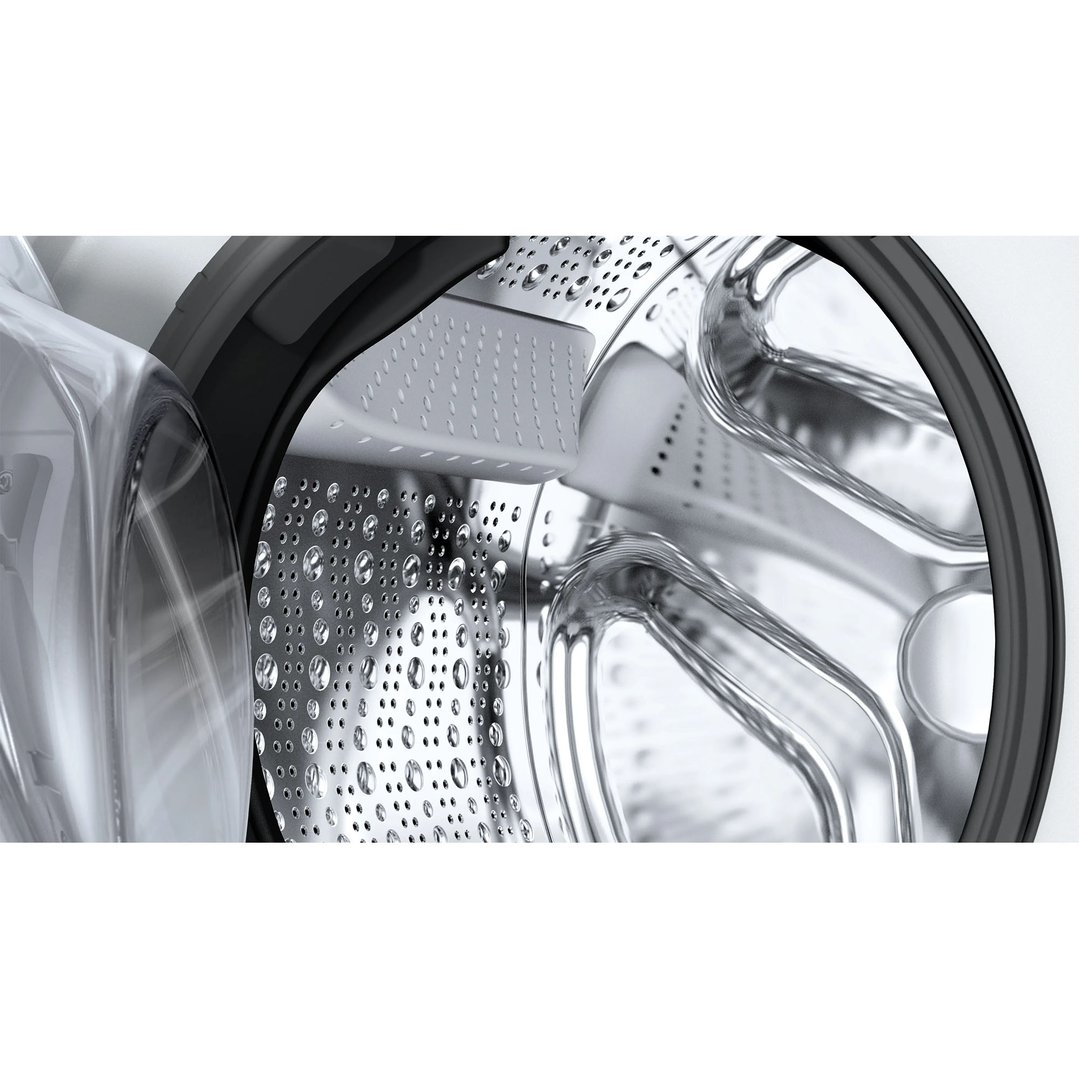 Close up of the washing machine drum with water droplets inside