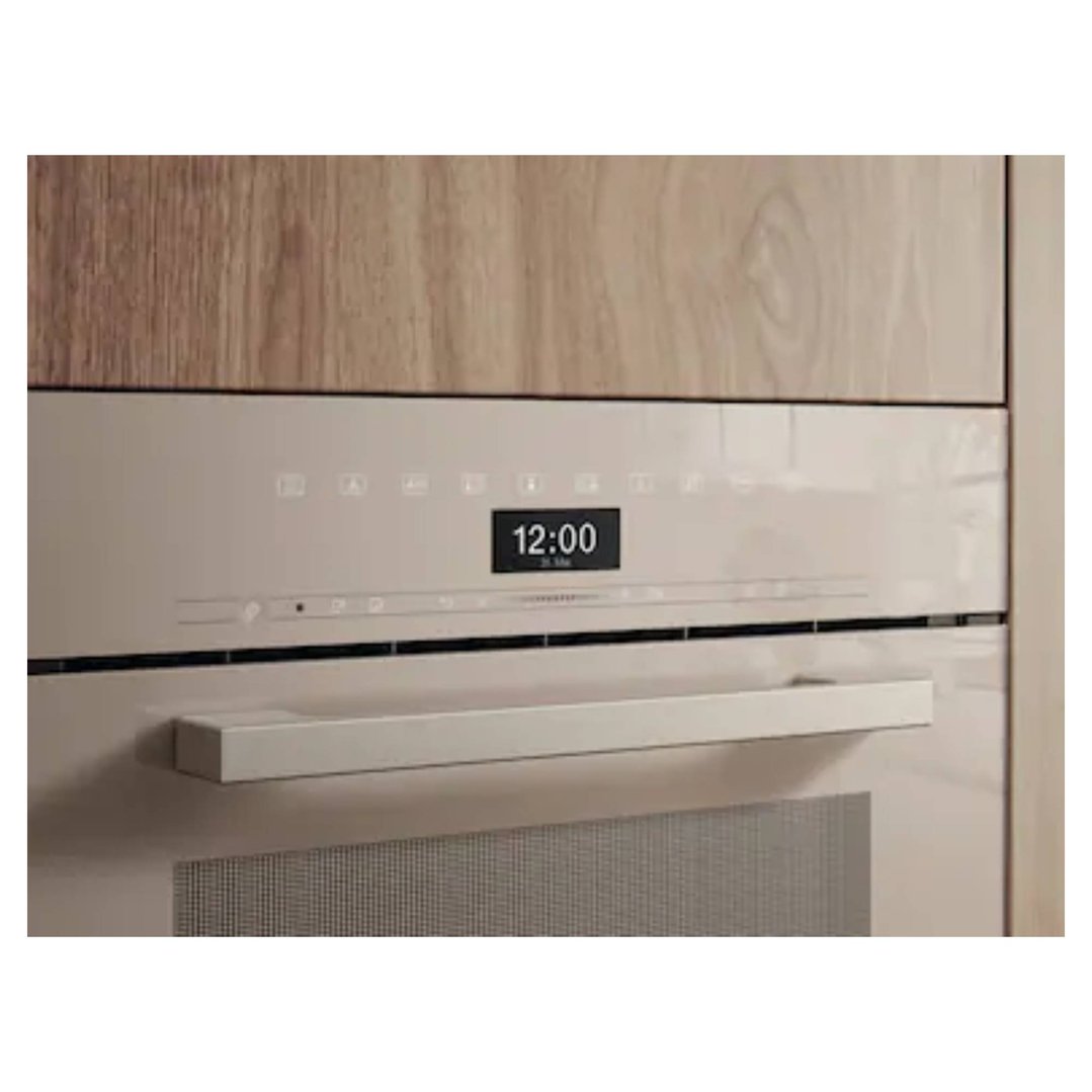 Built-in combination steam oven with digital display showing 12:00 in a kitchen