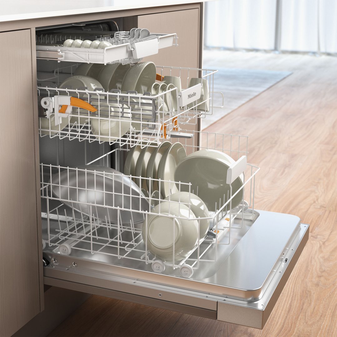 Open dishwasher with two racks of dishes in a kitchen setting