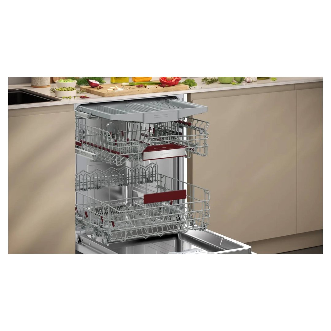 Fully-integrated dishwasher with open door and empty racks in a modern kitchen