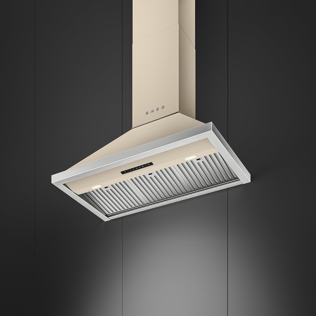 A cream Smeg rangehood with silver trim against a dark grey wall