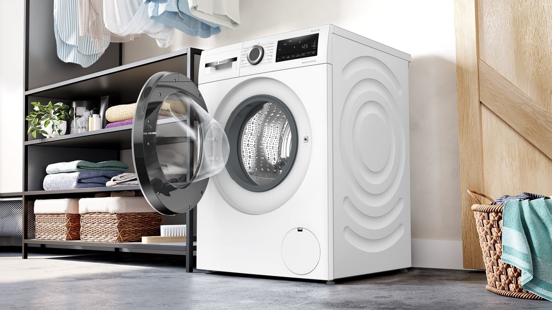 Bosch 10/5kg washer dryer combo with door open in a laundry room