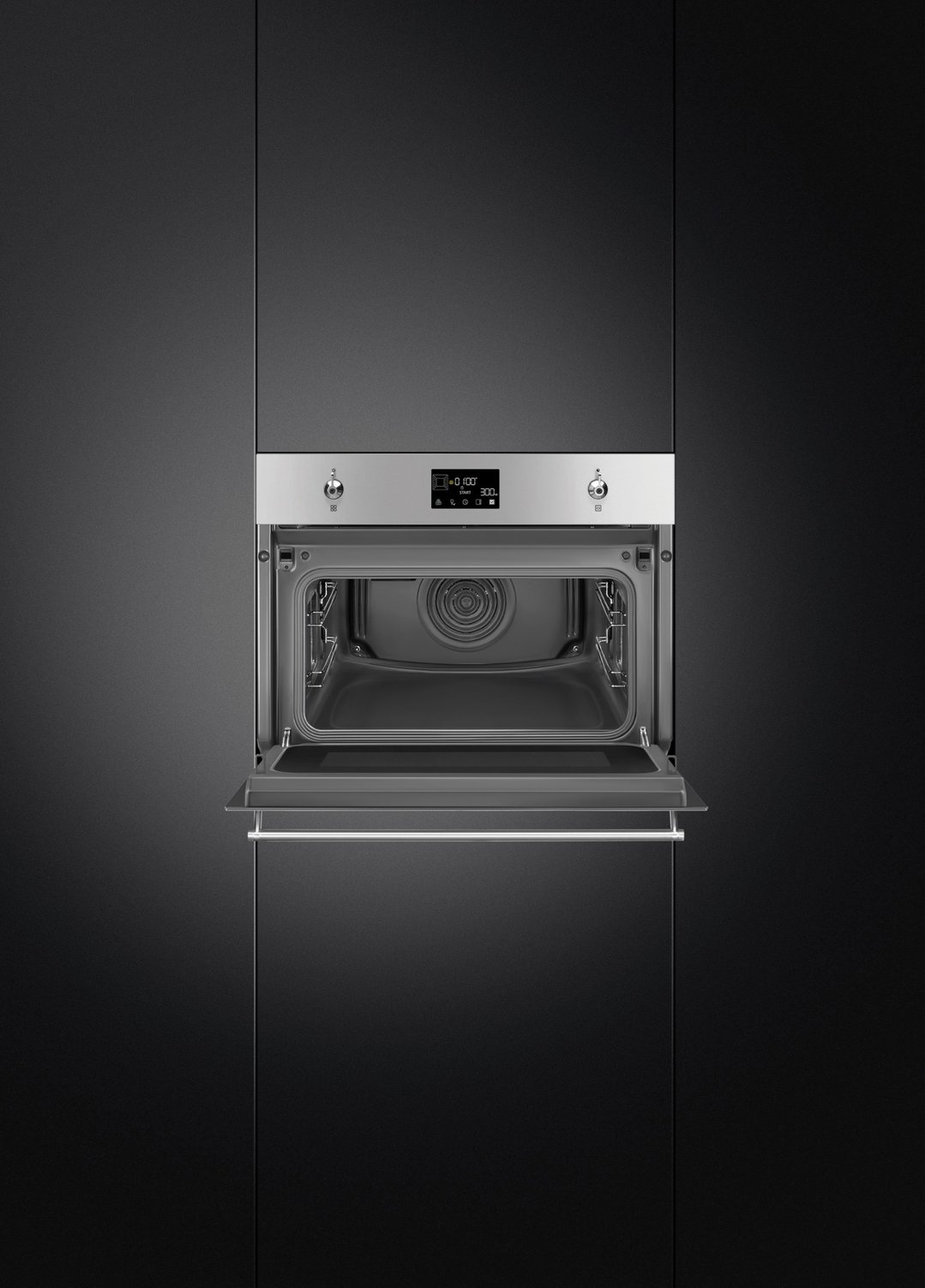 Built-in stainless steel compact speed oven with door open in a dark kitchen