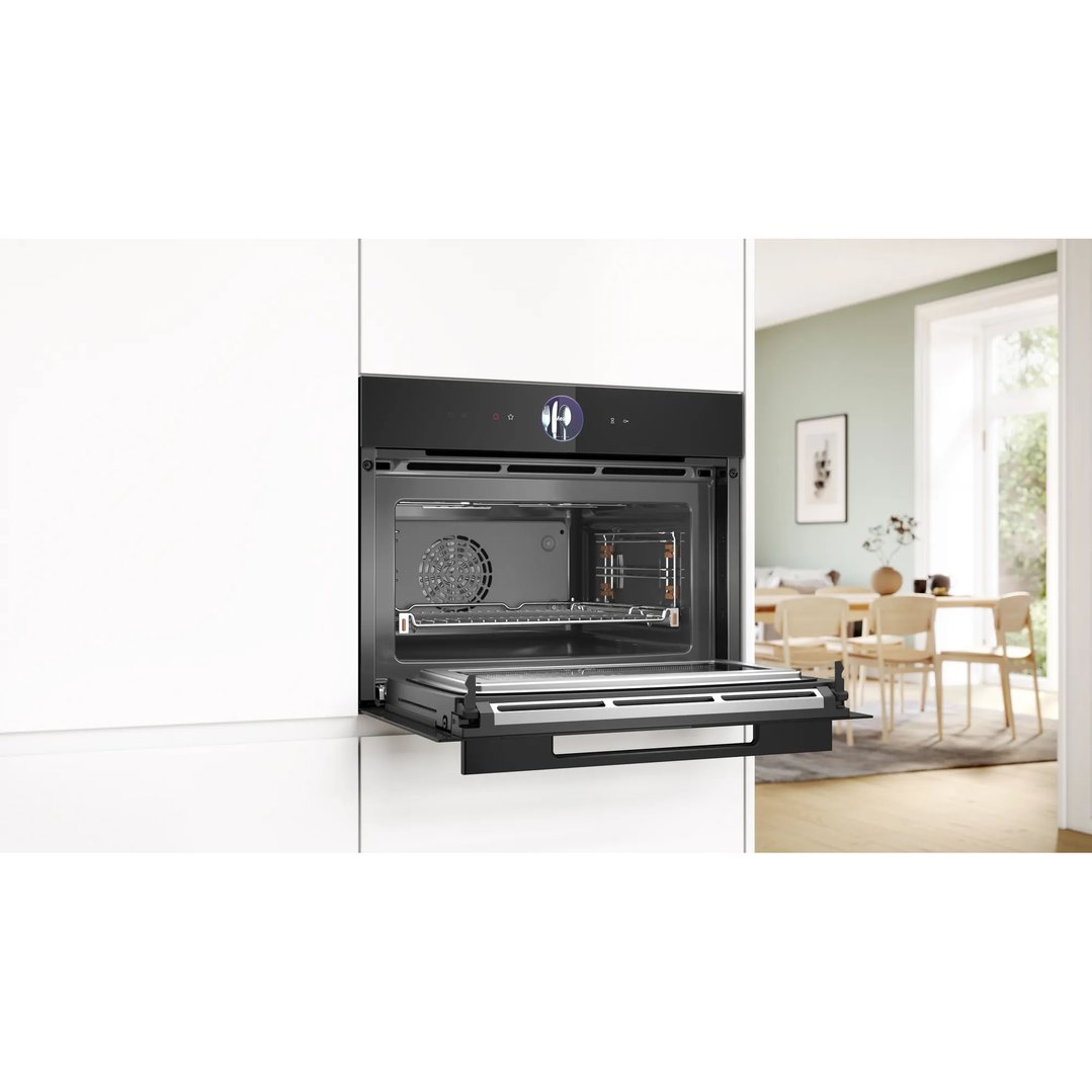 Open combination oven with microwave in a modern kitchen setting