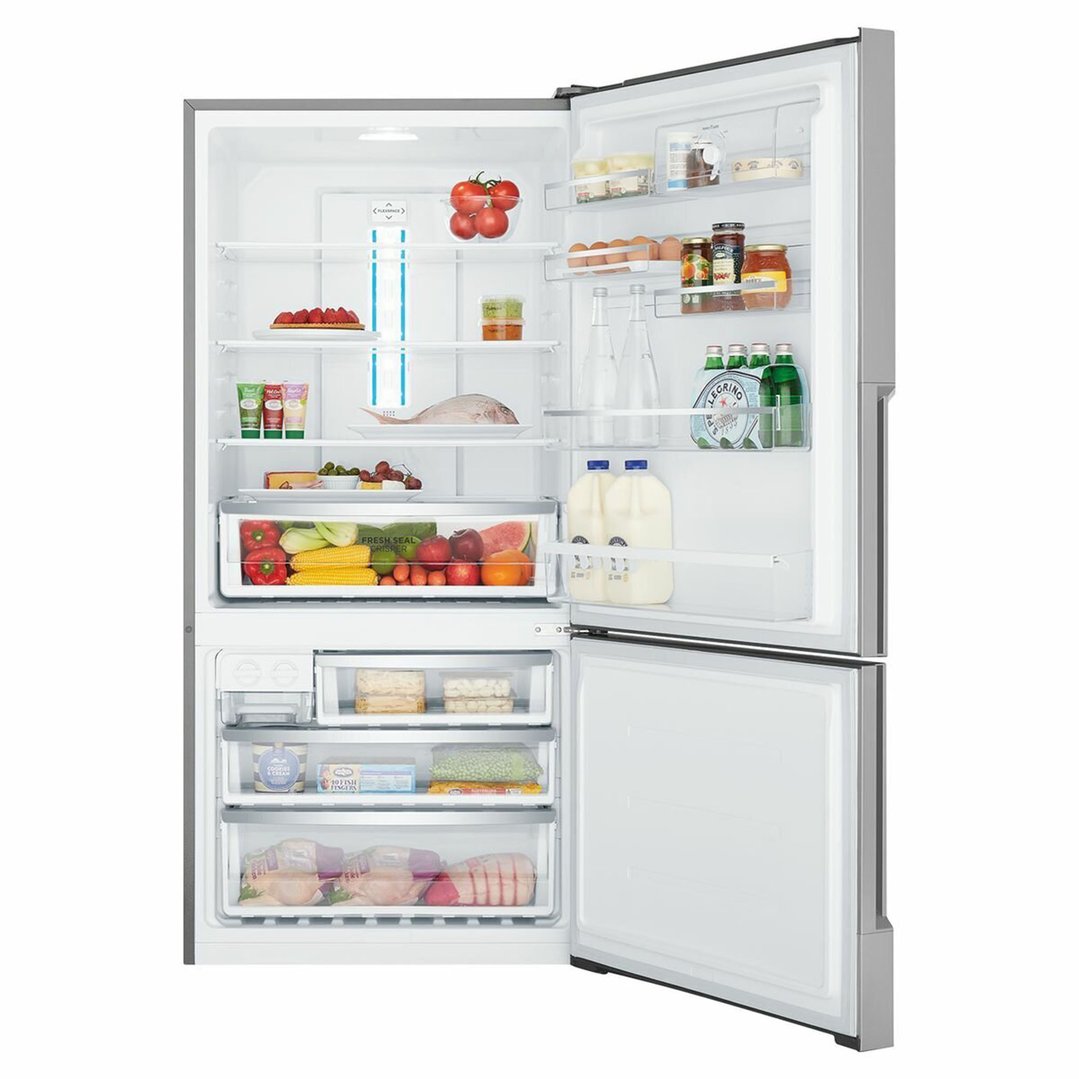 Open bottom mount refrigerator filled with food and drinks