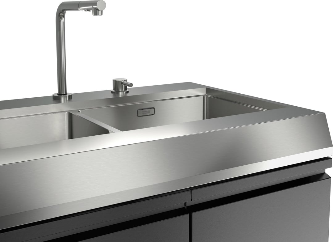 Close up of a stainless steel outdoor kitchen sink module with a tap