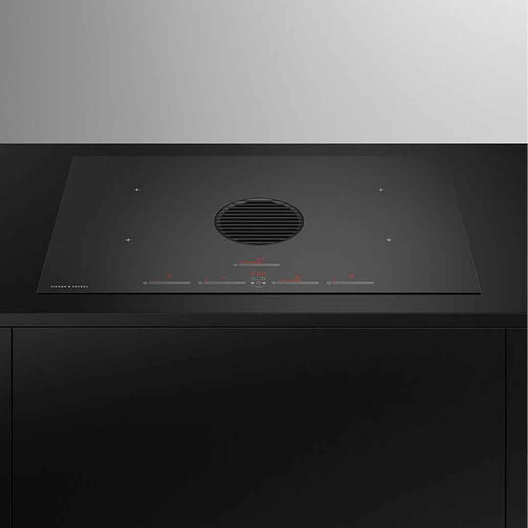 Black induction cooktop with integrated ventilation in a modern kitchen setting