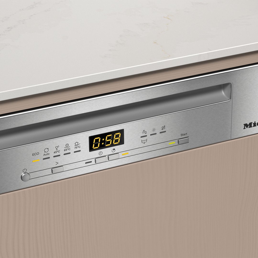 Close up of a semi-integrated dishwasher with a digital display showing 0:58
