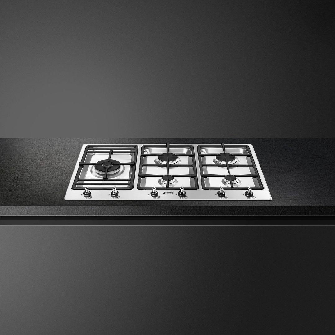 SMEG cooktop with five burners built into a dark kitchen countertop