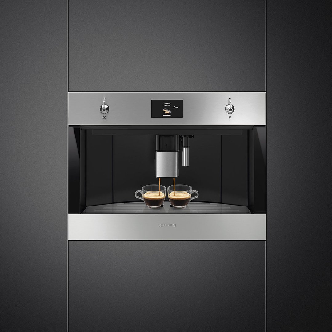 Built-in coffee machine dispensing espresso into two clear cups