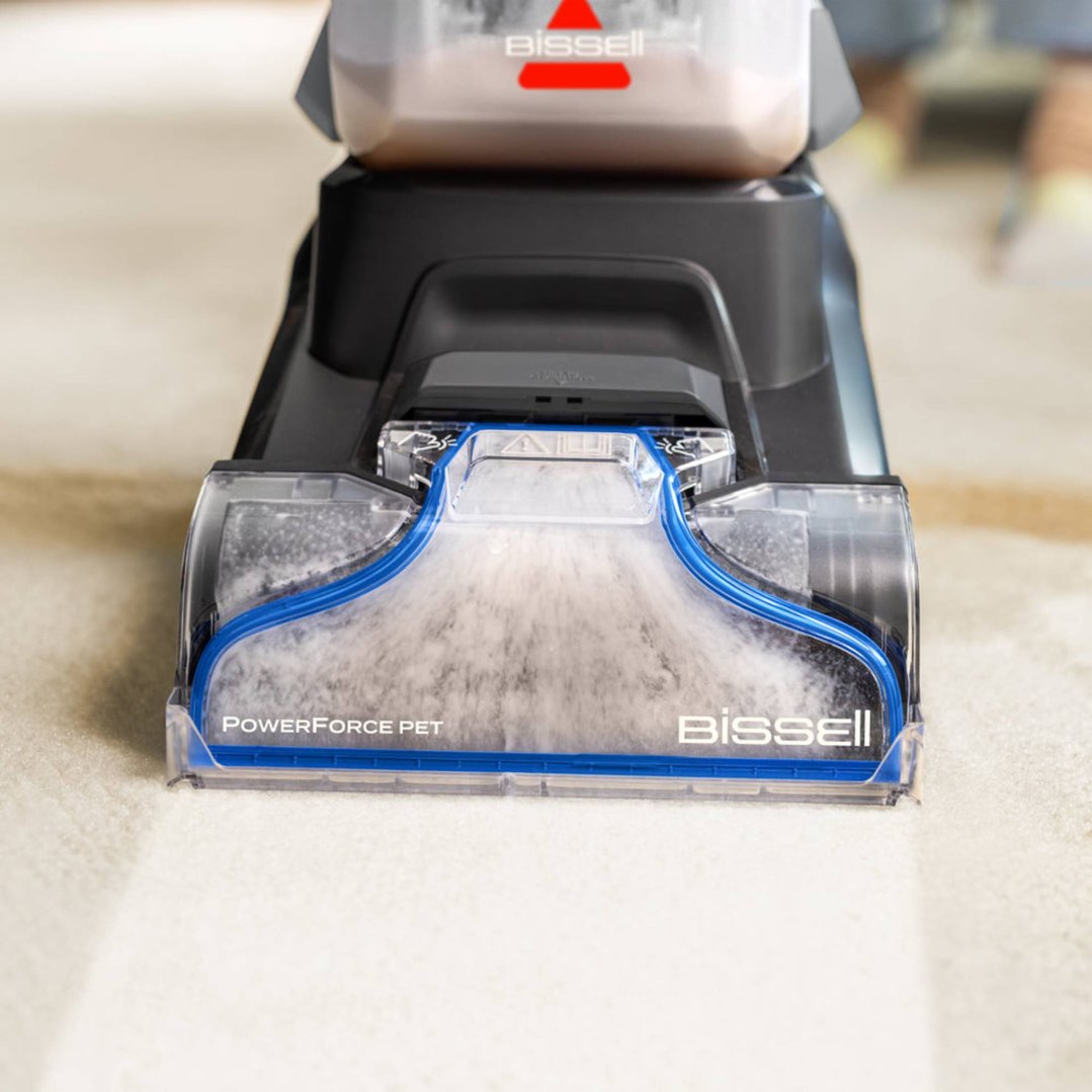 BISSELL PowerForce Pet carpet cleaner cleaning a light-colored carpet, close-up view