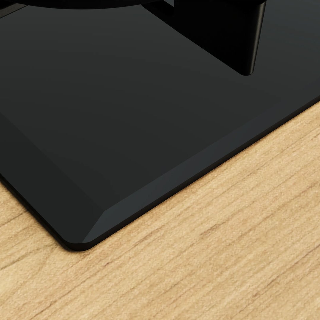 Black gas cooktop on a light wood countertop, close-up, angled view