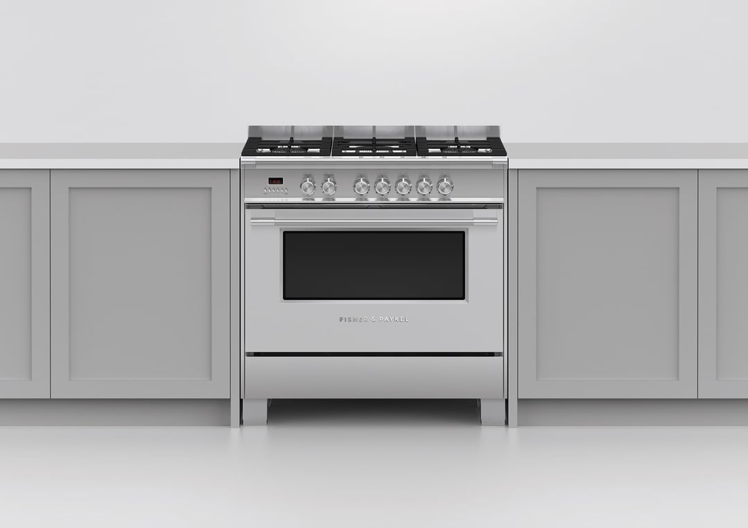 Stainless steel dual fuel cooker in a kitchen with light grey cabinets