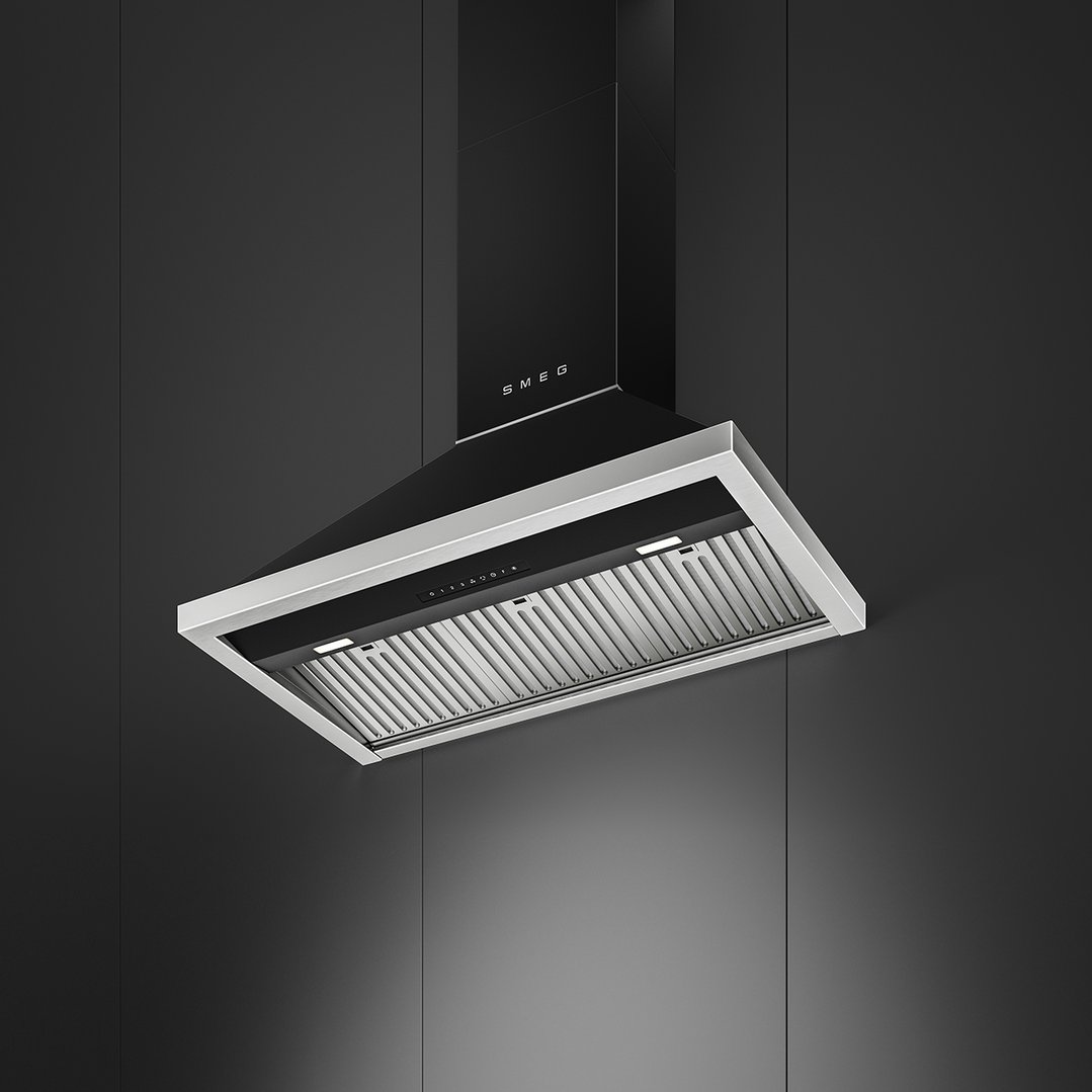 Black Smeg canopy rangehood with silver trim in a dark kitchen setting